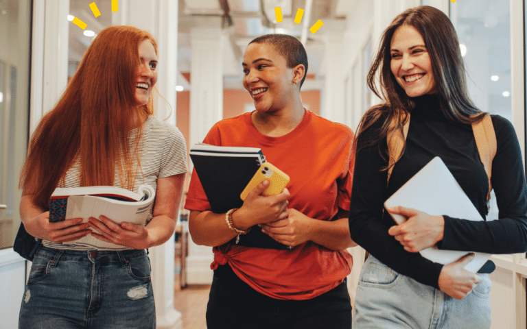 three people walking together down a hall holding books and phones