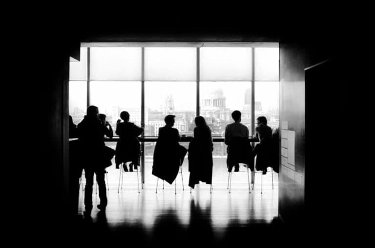 black and white photo of people sitting at tables