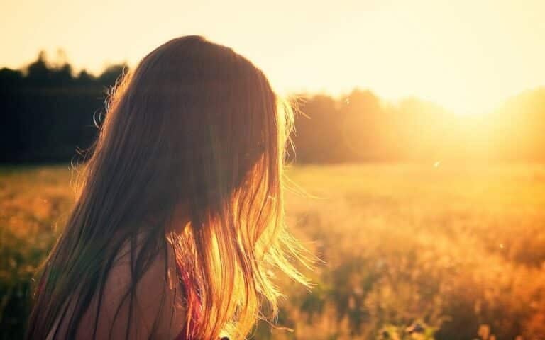 girl with long hair with slight behind her