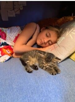 girl sleeping with a cat