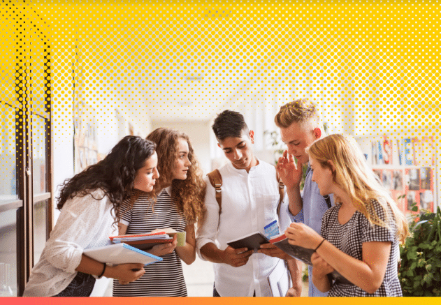 group of people looking at booklet