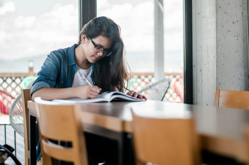 girl writing in a book