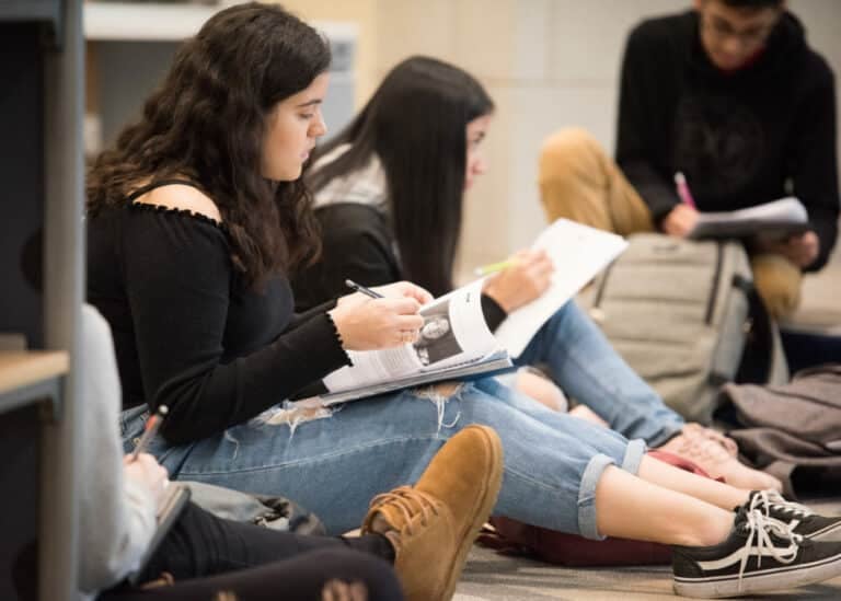 students looking at school work