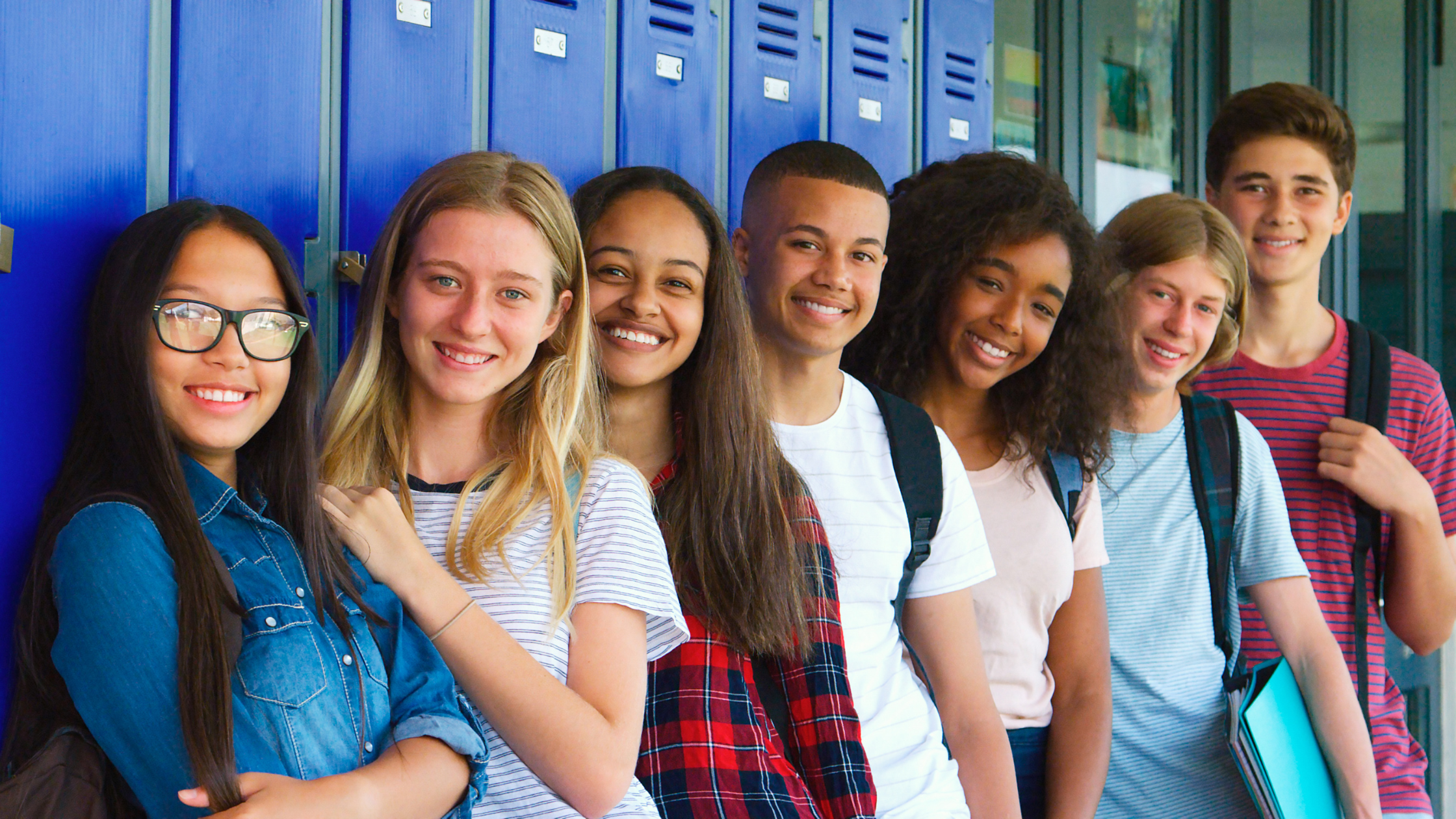 A diverse group of high school students happy to win an award. 